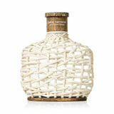 John Varvatos Artisan Pure fragrance bottle with woven white exterior and wooden cap.